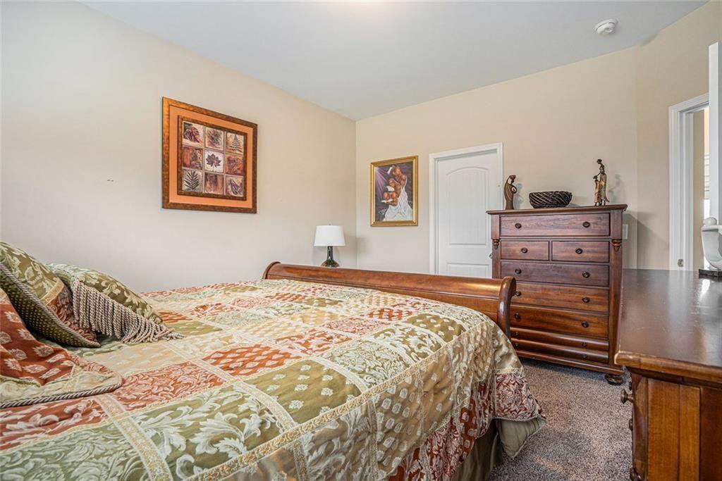 3478 In Bloom Way Auburn, GA 30011 - Photo 22 of 32 a bedroom with a bed and lamp