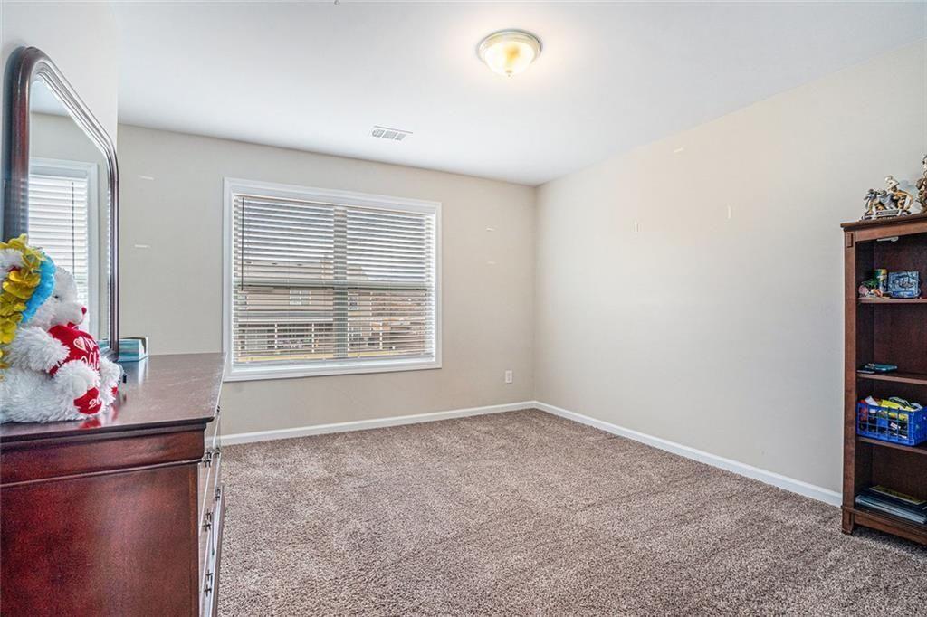 3478 In Bloom Way Auburn, GA 30011 - Photo 26 of 32 a room with toys and shelf