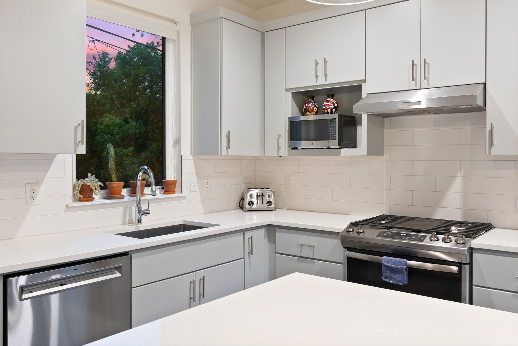1709 Perez Street, Unit 2 Austin, TX 78721 - Photo 11 of 33 A well-equipped kitchen features sleek counters, ample cabinetry, and stainless steel appliances.