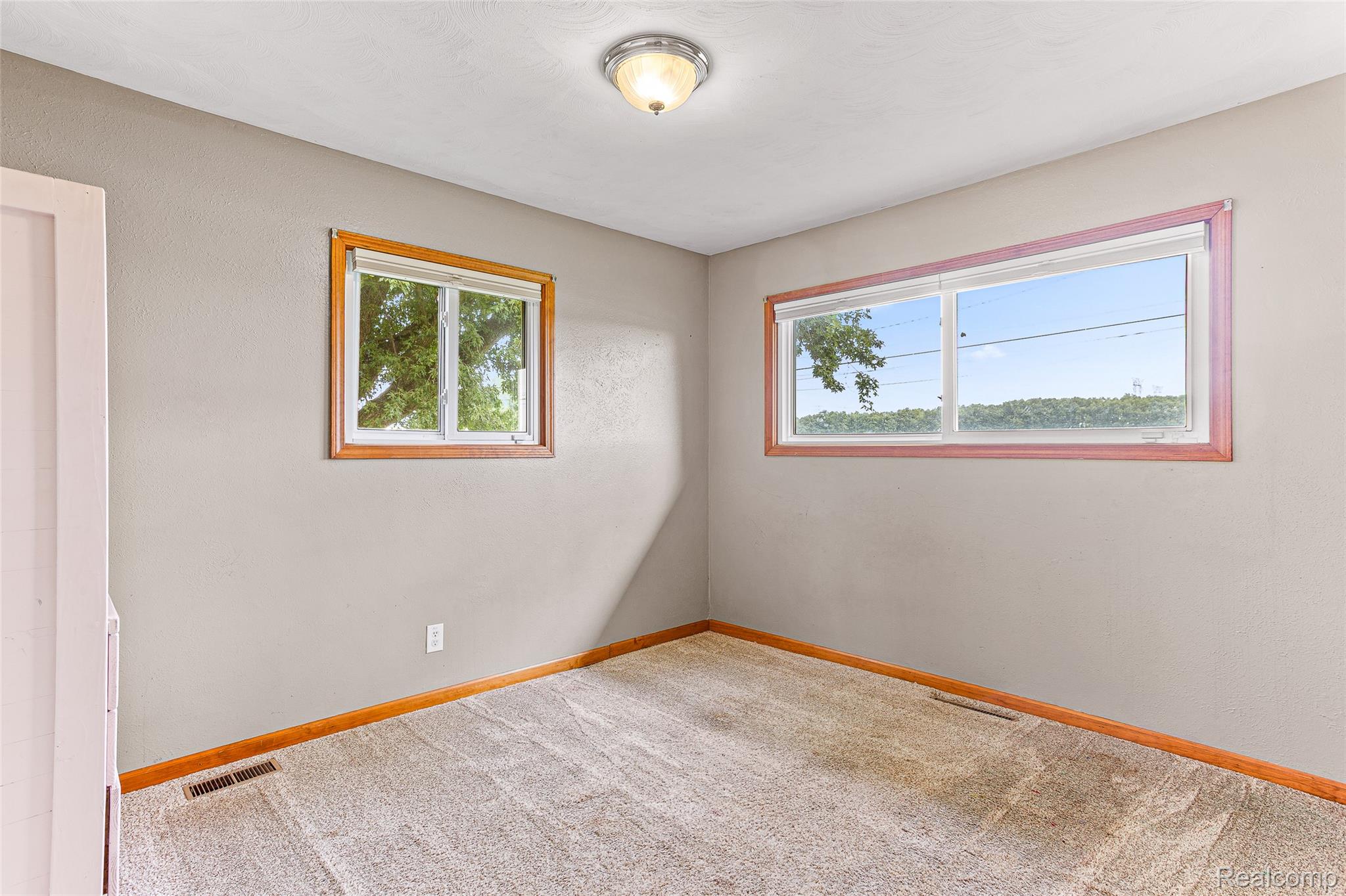 9561 Exeter Road Carleton, MI 48117 - Photo 29 of 46 Neutral wall paint with wood-frame windows, offering natural illumination