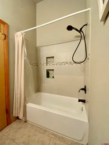 a bathroom with a shower and a bathtub