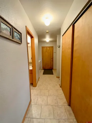 a view of a hallway with wooden shelves