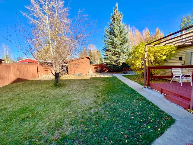 a view of a backyard with a garden and entertaining space