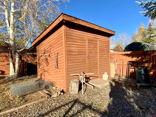 a backyard of a house with table and chairs