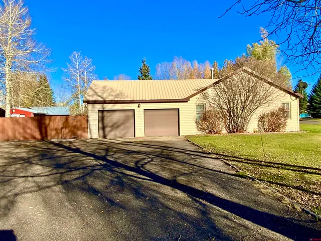 a view of a house with a snow on the road