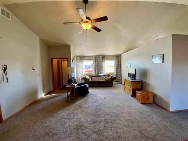 a living room with furniture and a gym machine