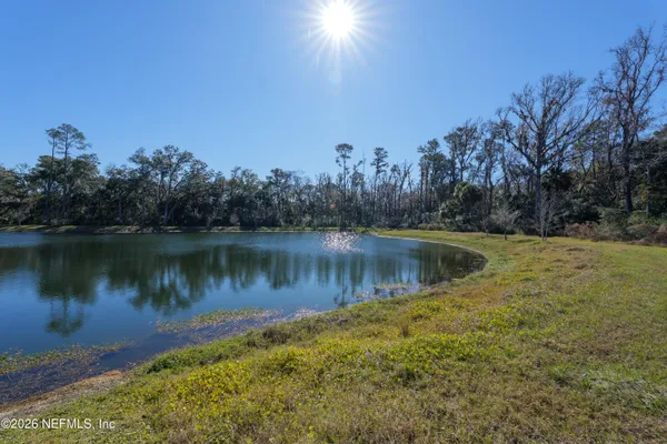 a view of a lake in between two of trees