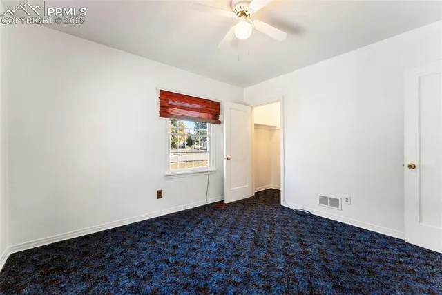 a very nice looking room with a ceiling fan and a window
