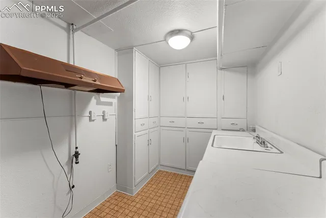 a utility room with cabinets washer and dryer
