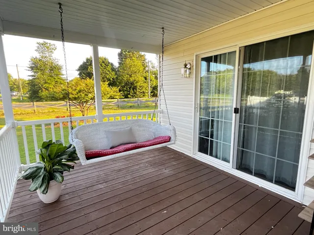 a view of a balcony with floor to ceiling windows wooden floor