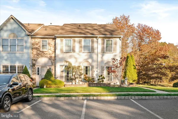 a couple of cars parked in front of a house