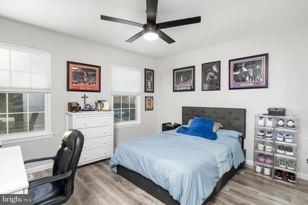 a bedroom with a bed chair and dresser