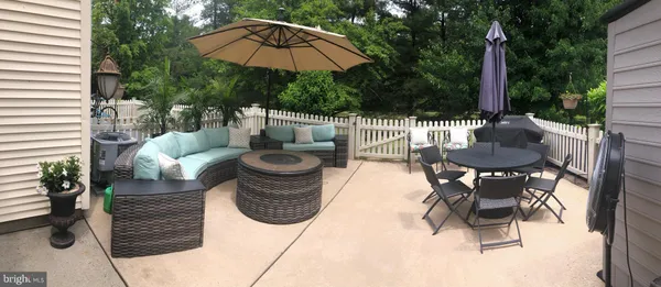 a view of outdoor dining space with a patio and a garden