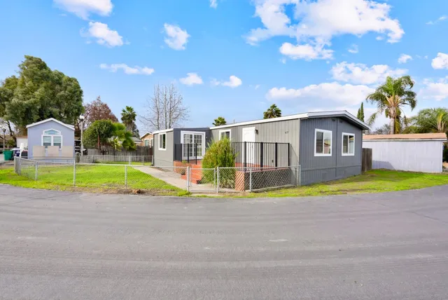 a view of a house with a swimming pool and a yard