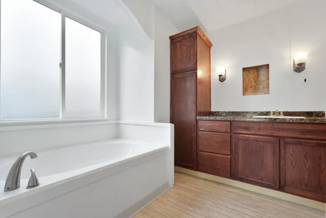 a bathroom with a bathtub and a sink