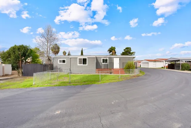 a view of a house with a swimming pool and a yard