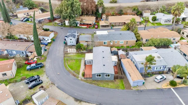 an aerial view of a swimming pool with outdoor seating