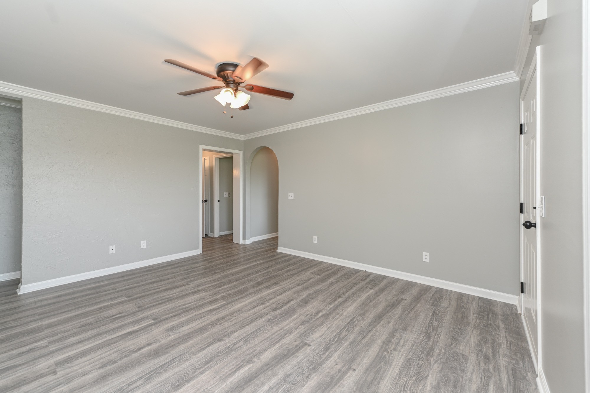 606 Cook Road Portland, TN 37148 - Photo 5 of 17 a view of an empty room with wooden floor and a ceiling fan