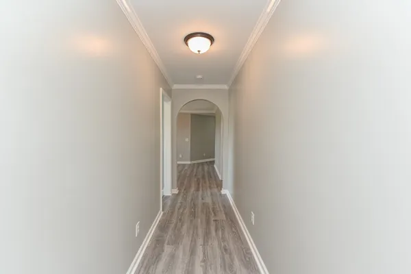 a view of a room with wooden floor and white walls