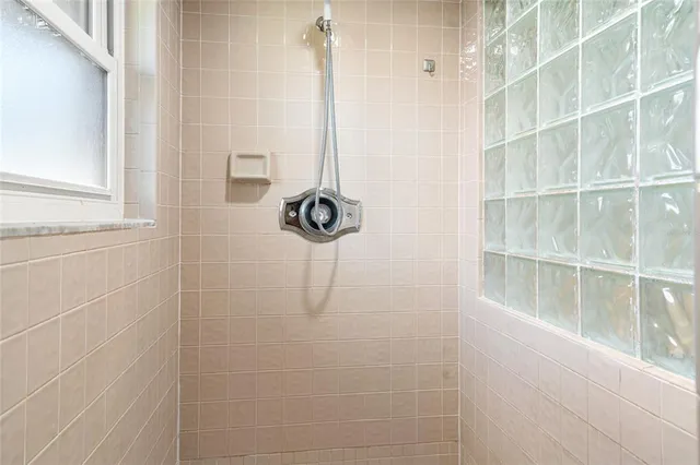 a kitchen with stainless steel appliances granite countertop a refrigerator a stove top oven a sink dishwasher and white cabinets with wooden floor