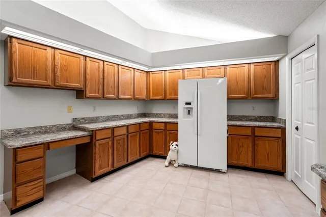 an empty room with fireplace fan and windows