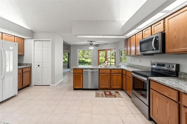 a living room with furniture a fireplace and a large window