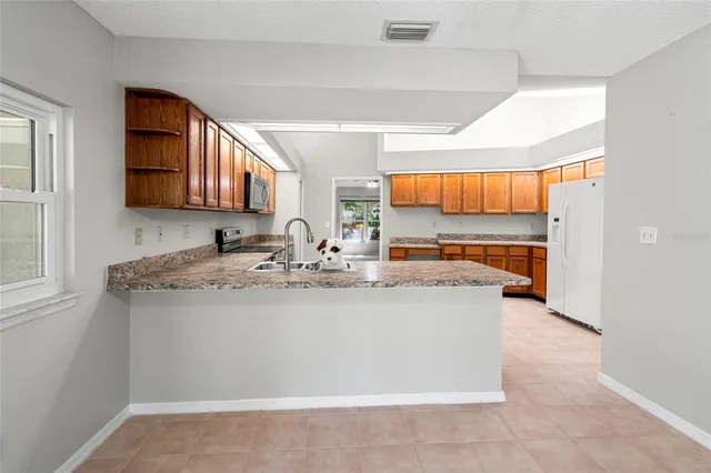 a view of an empty room with window and fire place