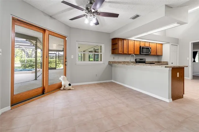 a view of a livingroom with a ceiling fan and window