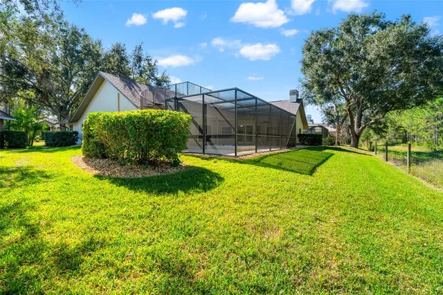 an aerial view of a house with a garden and lake view