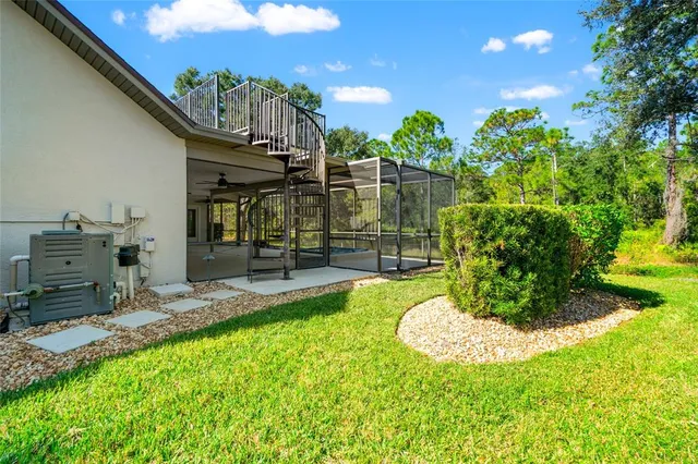 an aerial view of residential houses with outdoor space and lake view