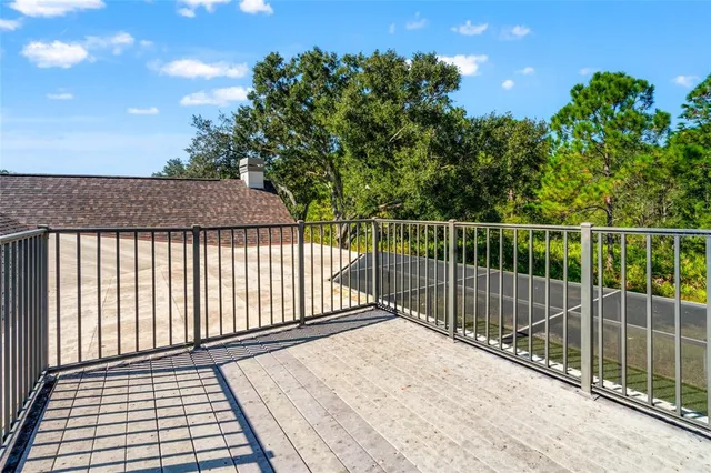 an aerial view of residential houses with outdoor space and trees