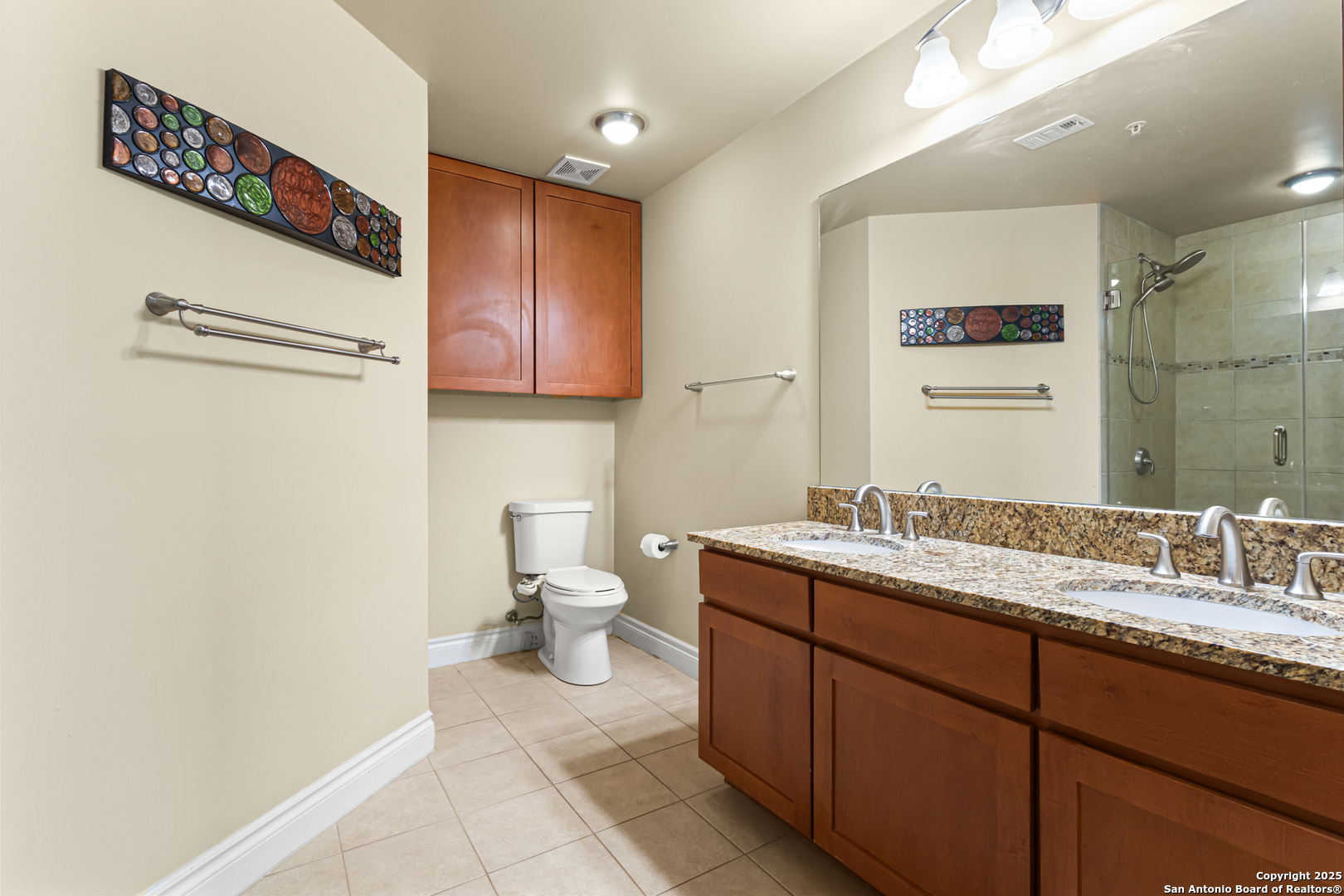 215 Center Street, Unit 1005 San Antonio, TX 78202 - Photo 11 of 29 a bathroom with a granite countertop sink toilet and mirror
