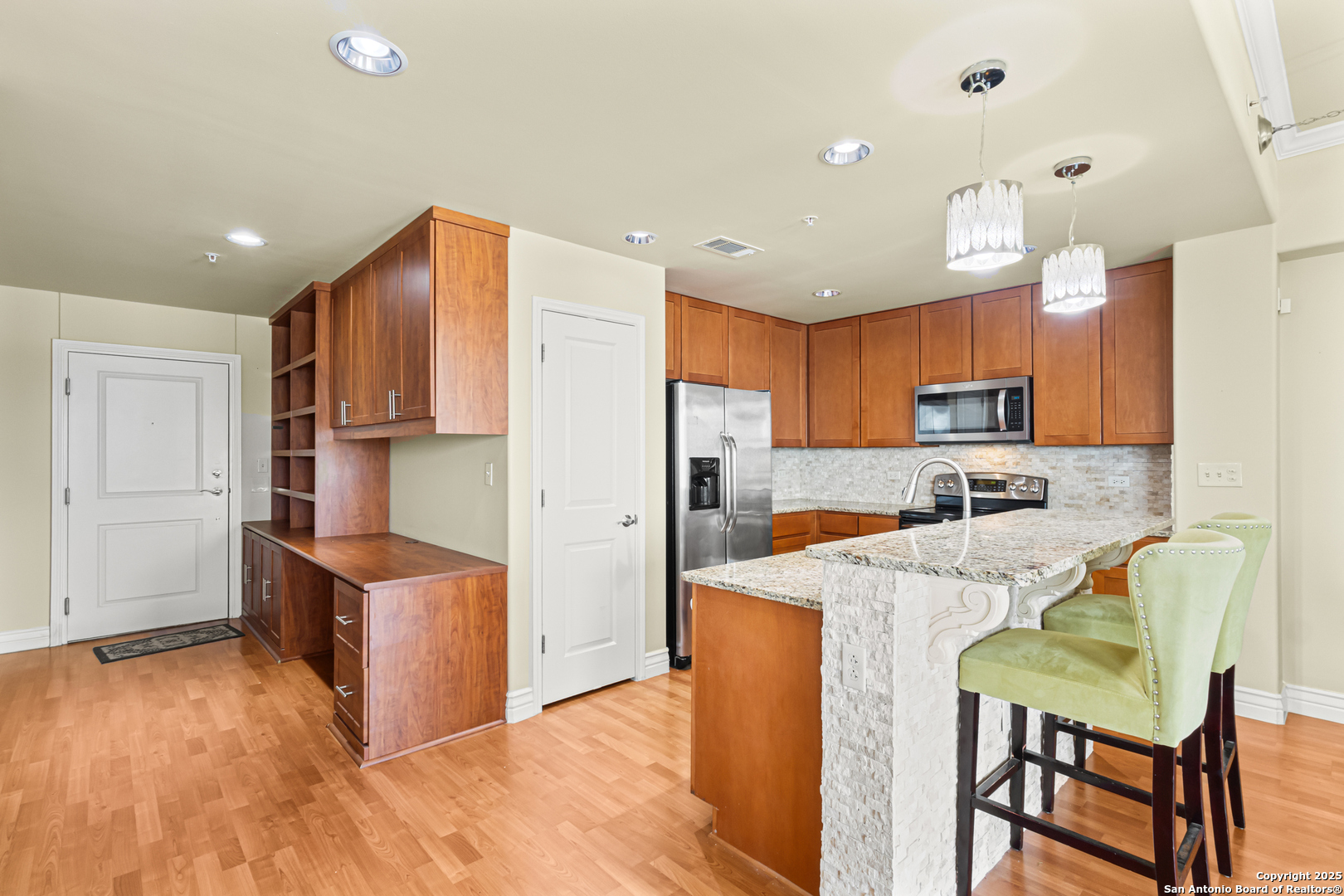 215 Center Street, Unit 1005 San Antonio, TX 78202 - Photo 2 of 29 a kitchen with stainless steel appliances granite countertop a refrigerator and a stove top oven