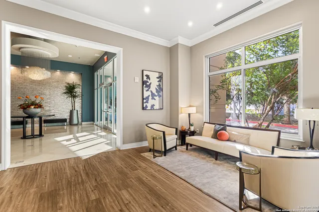 a living room with furniture and a large window