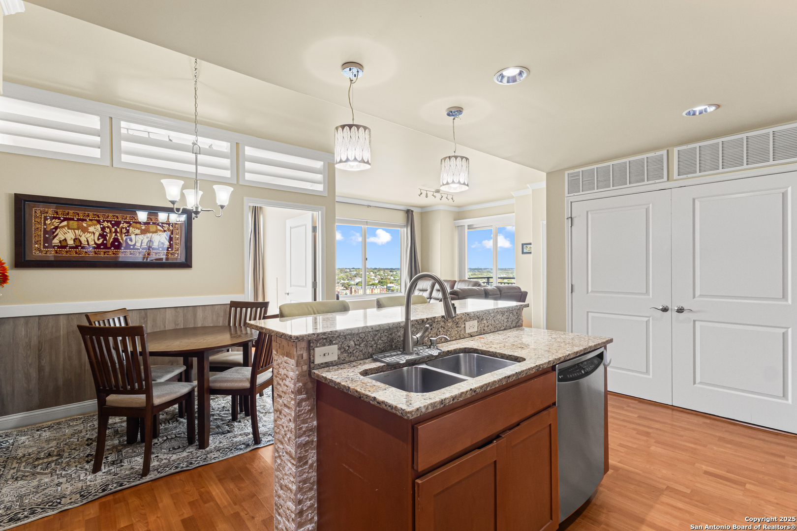 215 Center Street, Unit 1005 San Antonio, TX 78202 - Photo 6 of 29 a kitchen that has a sink a table and chairs in it