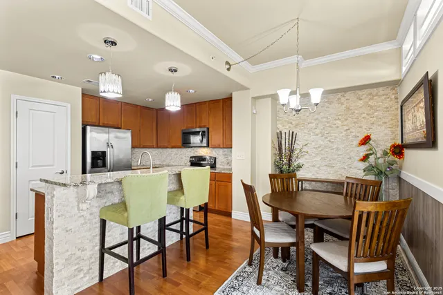 a view of a dining room with furniture and a kitchen