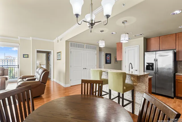 a view of kitchen with refrigerator and wooden floor