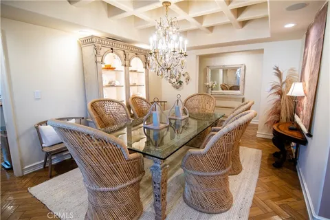 a dining room with furniture and a chandelier