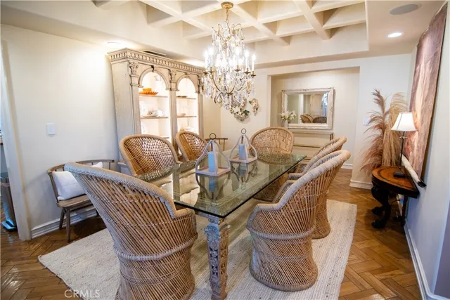 a dining room with furniture and a chandelier