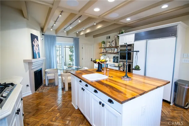 a room with furniture pool table flat screen tv and windows