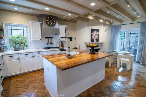 a kitchen with kitchen island granite countertop a sink and cabinets