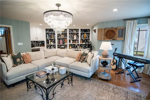 a living room with furniture a rug and a chandelier
