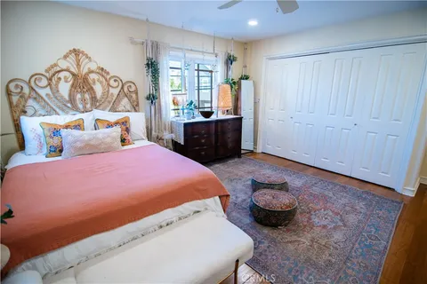 a bed room with a bed and a chair