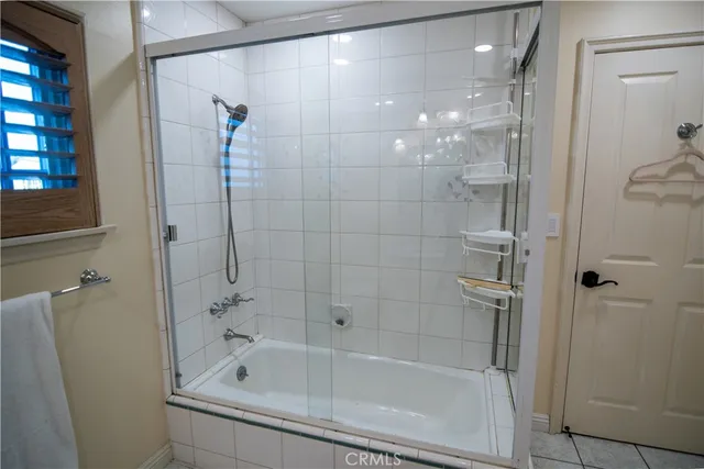 a bathroom with a shower and a bath tub