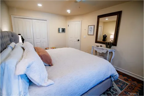 a bedroom with a bed and a mirror