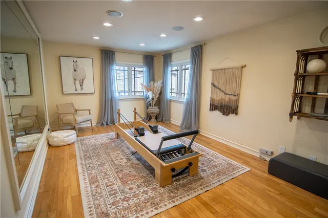 a living room with furniture a rug and a flat screen tv