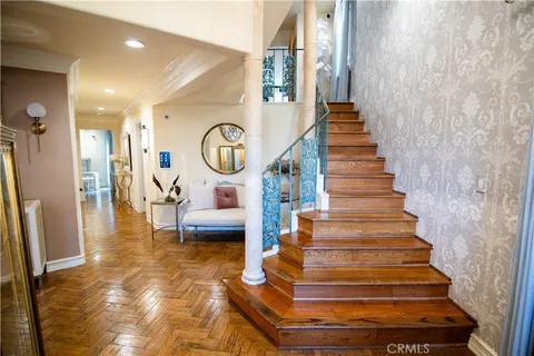 a view of entryway and hall with wooden floor