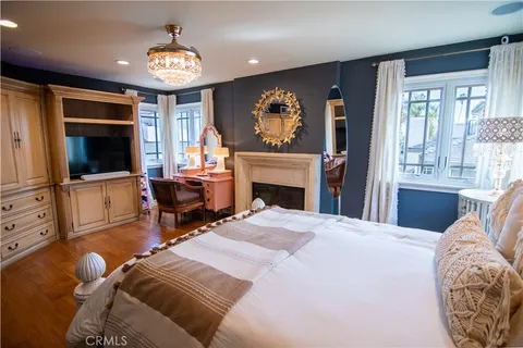 a bedroom with furniture and a fireplace