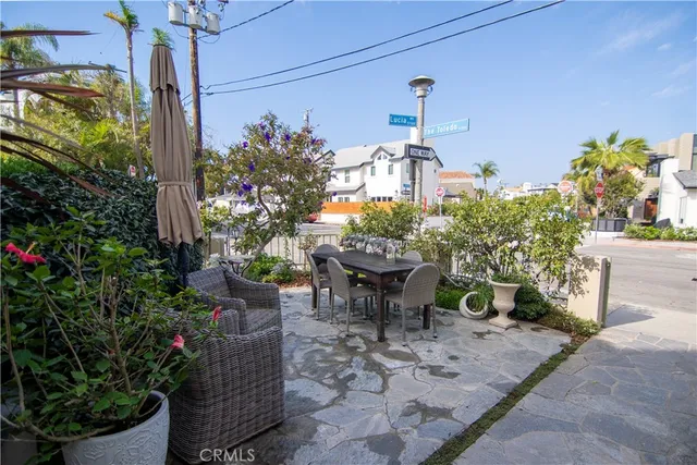 a view of a patio with table and chairs potted plants