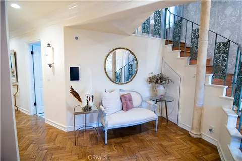 a living room with furniture a rug and a wooden floor